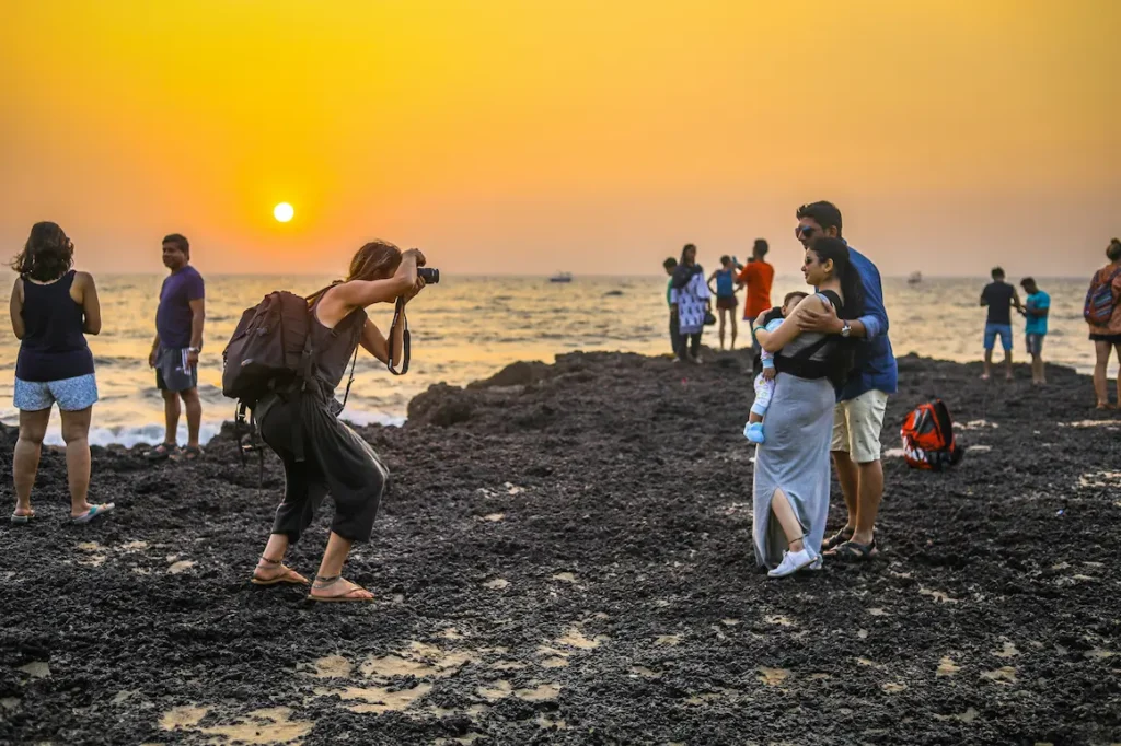 Families enjoying the sunset on Kerala Beach, India.