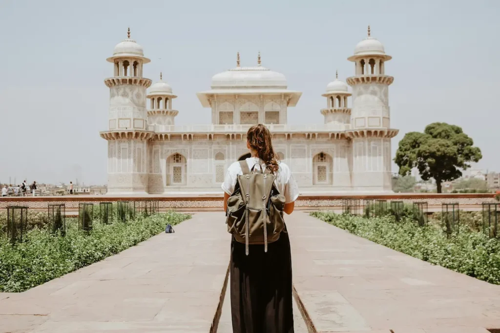 Women standing in full covered dress in an Indian historical site, Agra.