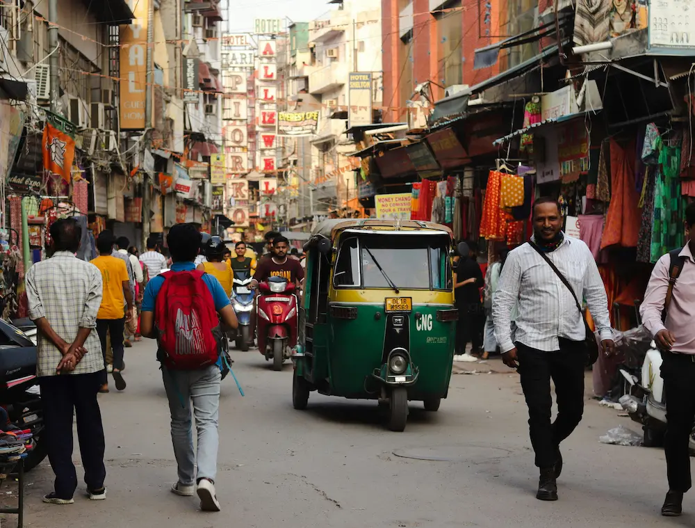 family crossing chaotic road in Delhi with kids