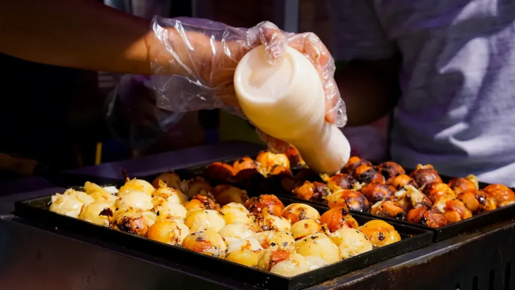 Takoyaki is the street snack Osaka is most famous for: crispy on the outside, with a chewy piece of octopus at the center. 