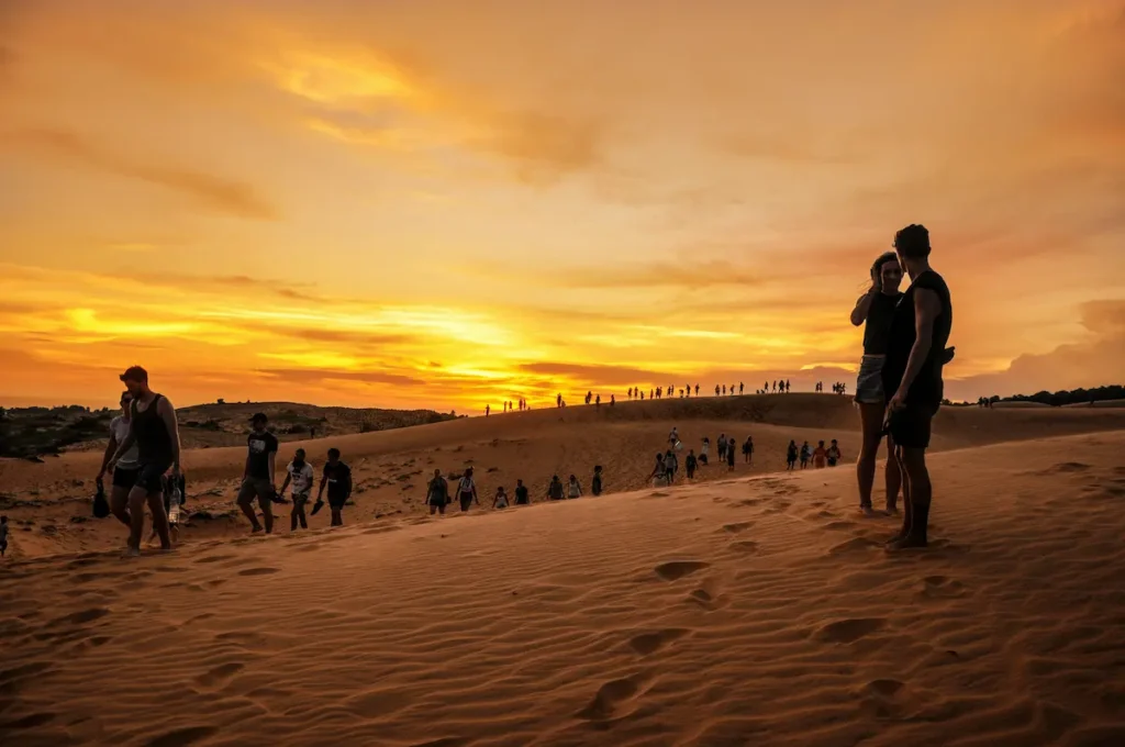 Sunset of Mui Ne, Vietnam, with kids on the dunes