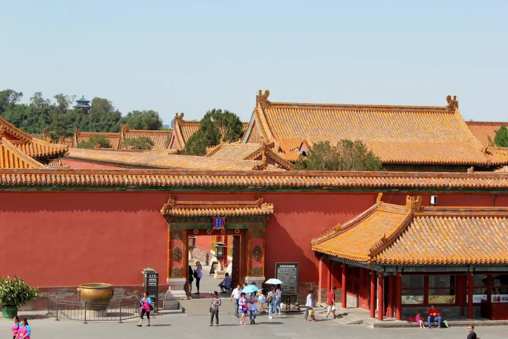 women with umbrellas and hats in summer in Beijing with kids