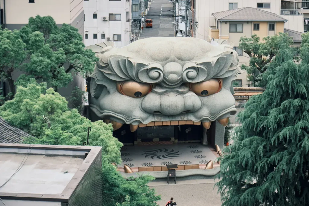 One of the most unforgettable things in Osaka with kids is visiting this small shrine, which stands out with its giant lion-head stage.
