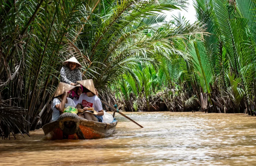 enjoy a boat ride or foot paddling locals in the Mekong Delta, Vietnam, with kids