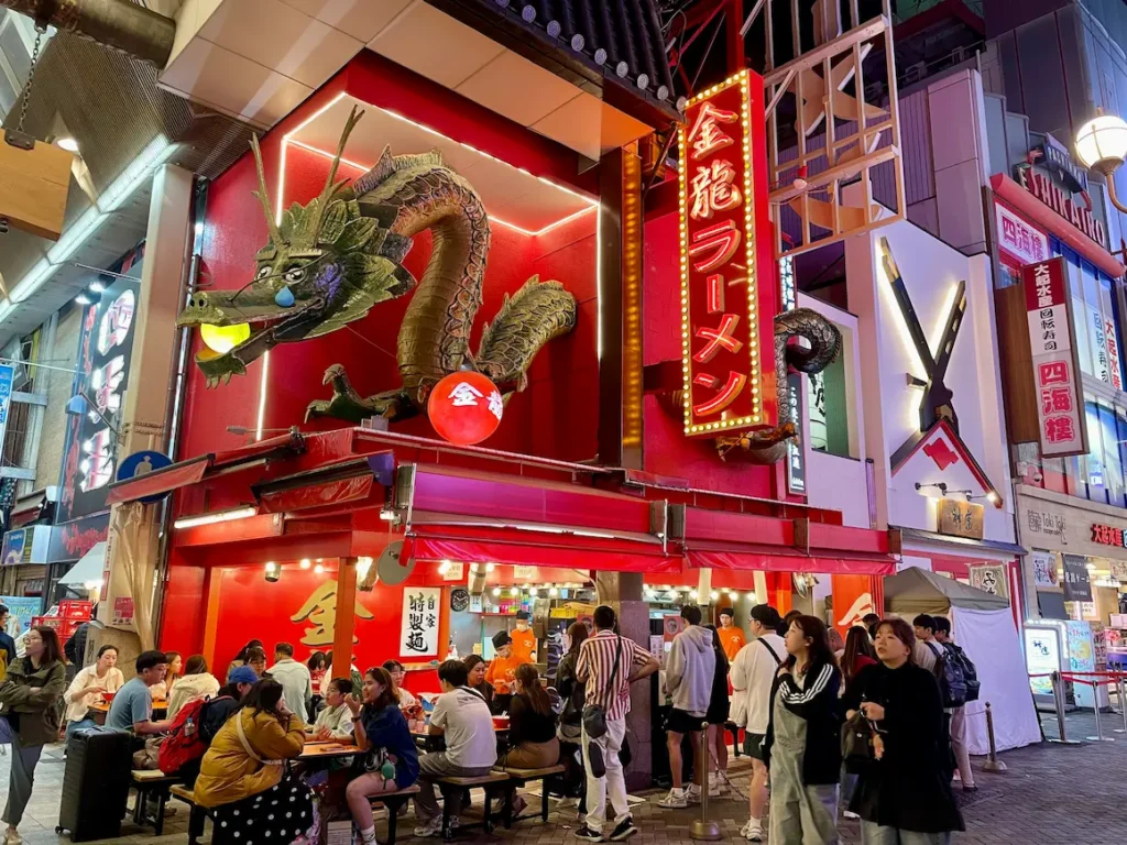 The view of the a corner street food cafe on Dontonbori Street, Osaka. 