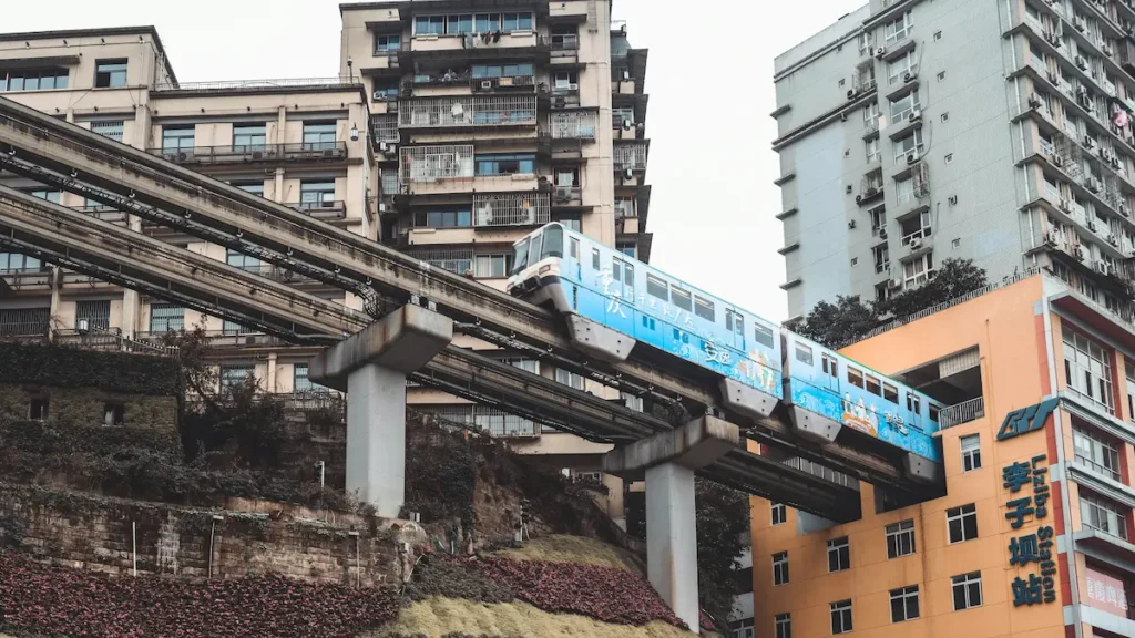 The CHONGQING train entering the residential building is best witnessed with kids, and capture their reaction. 