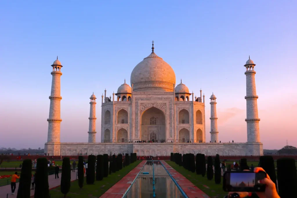 man capturing pic of Taj Mahal with phone