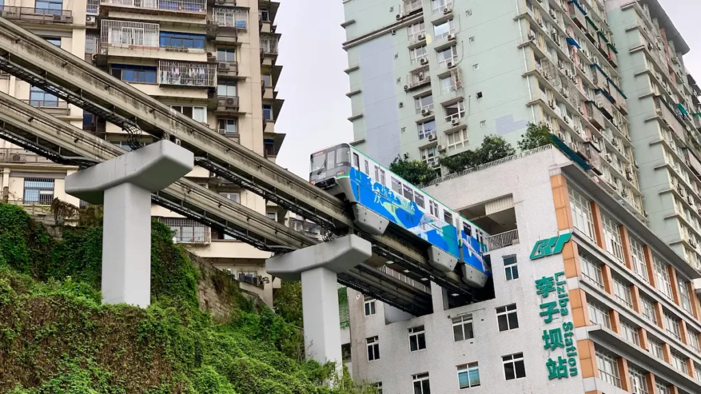 The CHONGQING train entering the residential building is best witnessed with kids, and capture their reaction. 