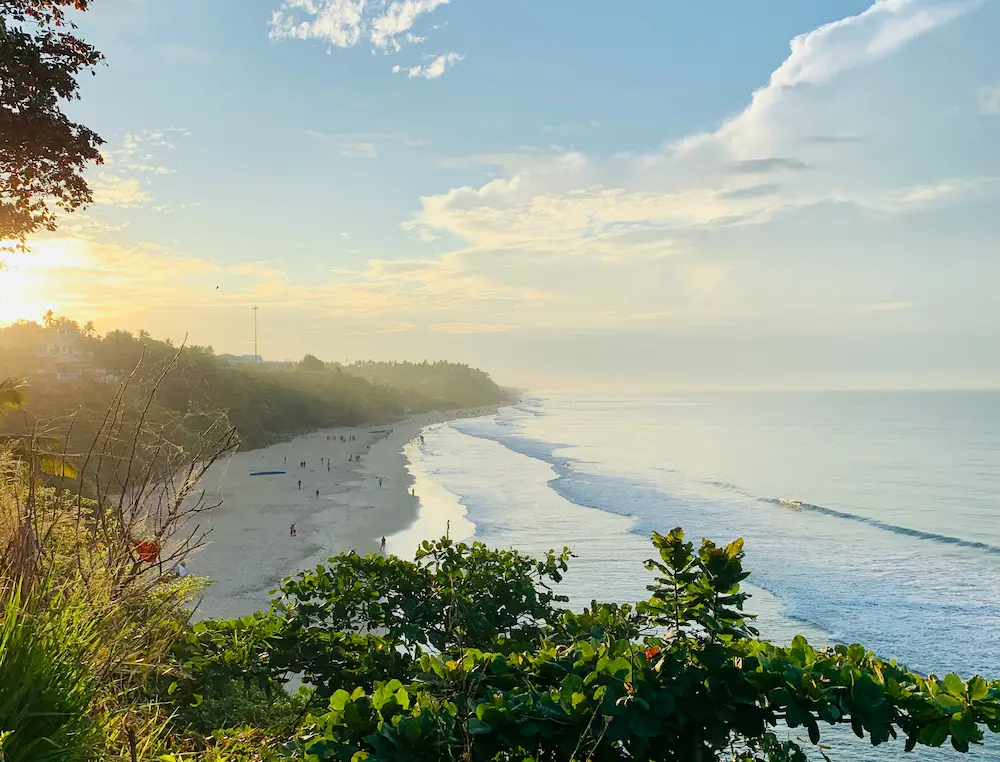 “Clifftop view of Varkala Beach at sunset with kids