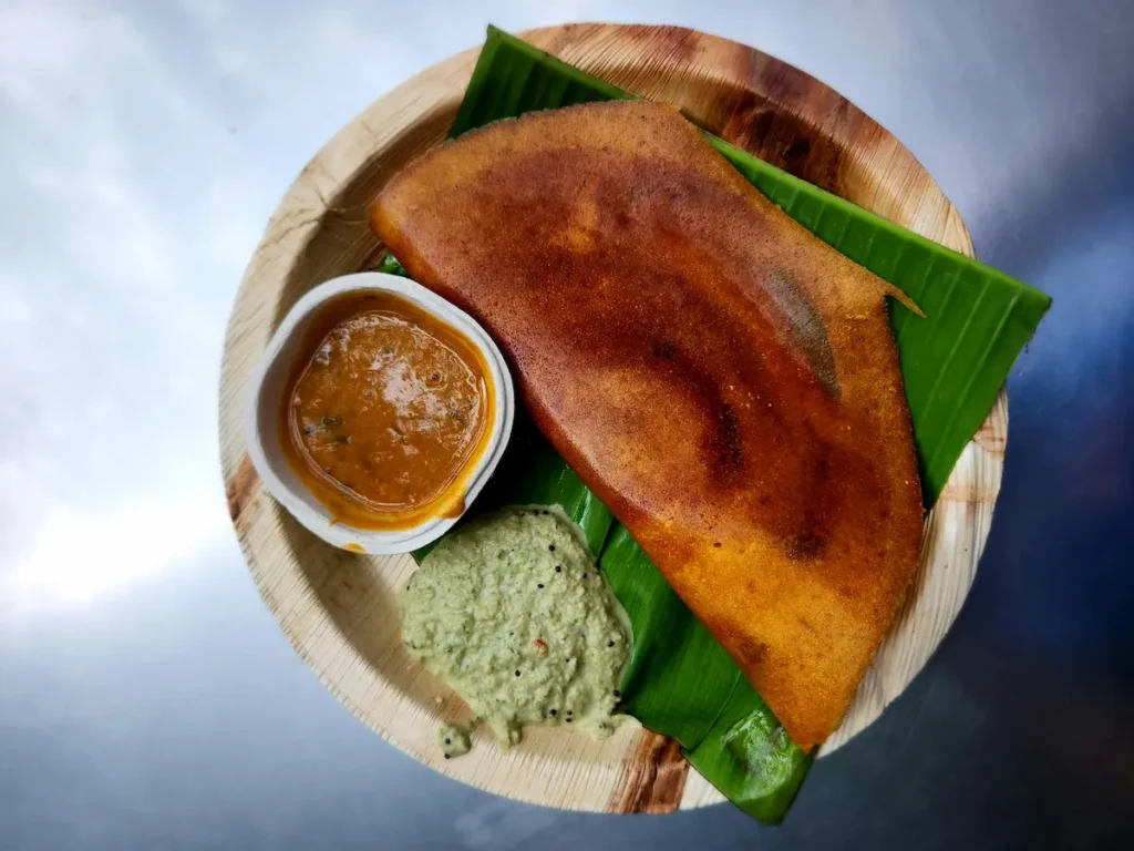 Keralan food is Dosa, Idli Appam served on a coconut leaf. 
