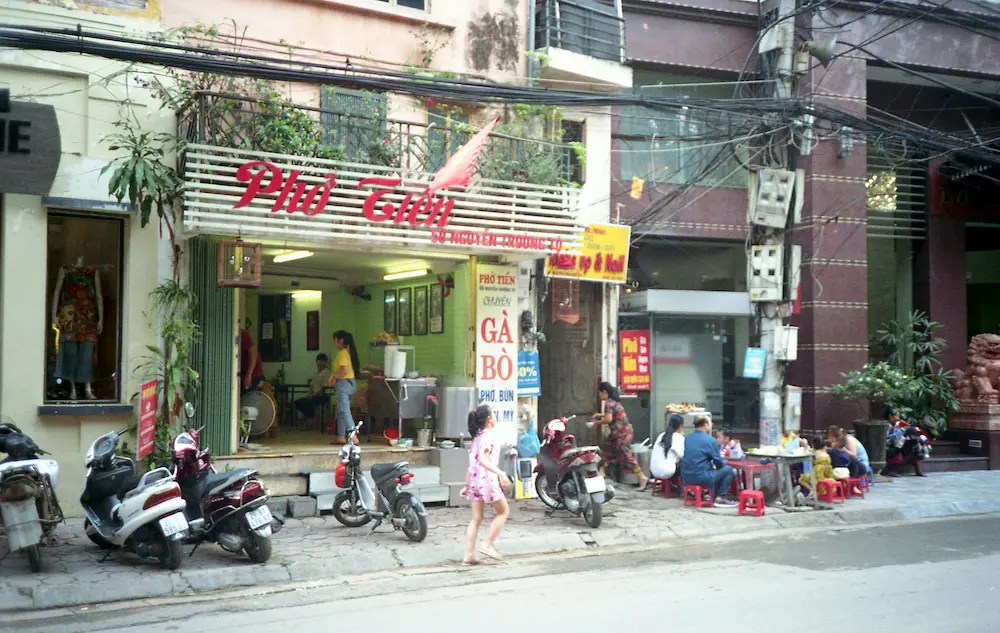 Family taking a break at a Hanoi cafe during a Vietnam trip with kids