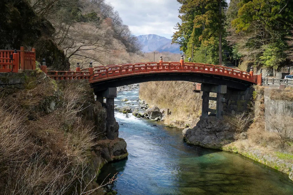 Family walking near red Shinkyo Bridge Nikko