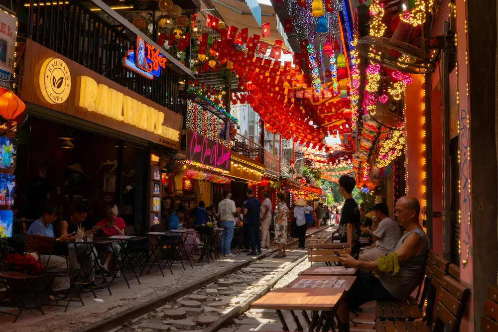 Hanoi Train Street viewed safely from a café with kids. 