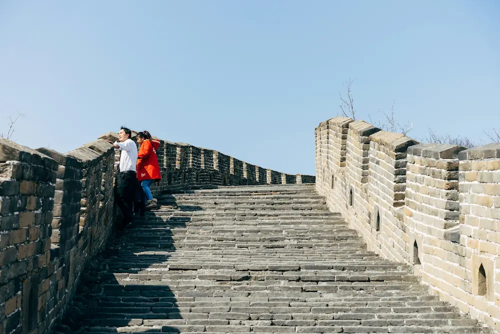 Taking breaks while climbing the Great Wall of China with kids is necessary.