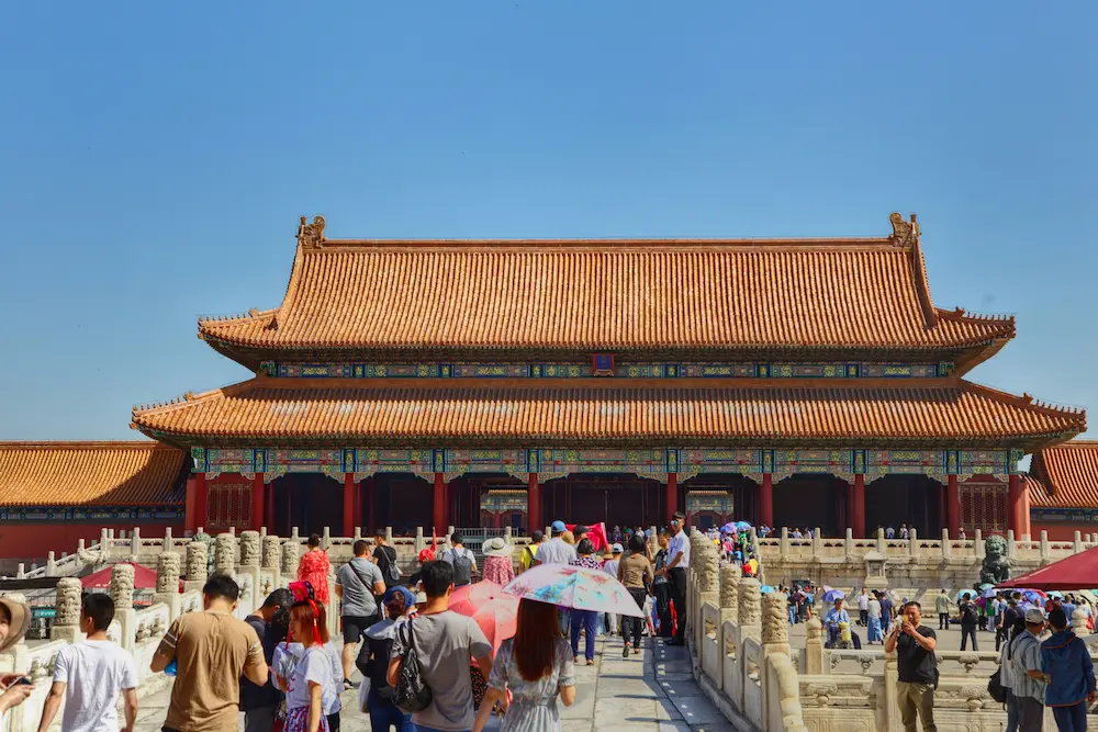 Family exploring a wide public square in Beijing with kids.