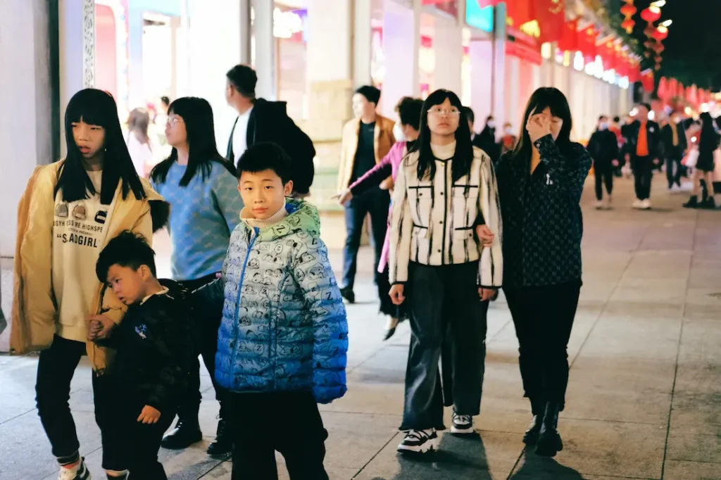 A tired toddler resting on a parent during a day out in Japan.