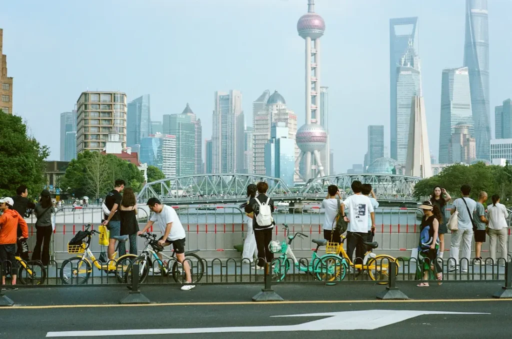 Parents and kids walking along a riverside promenade in Shanghai.