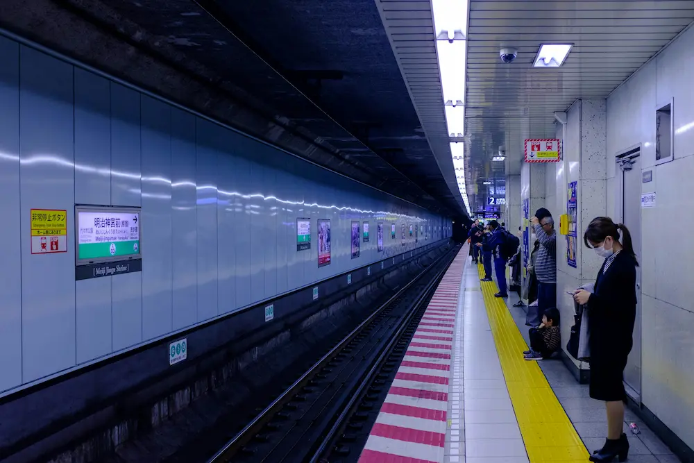 family Using a subway at a Japanese train station.
