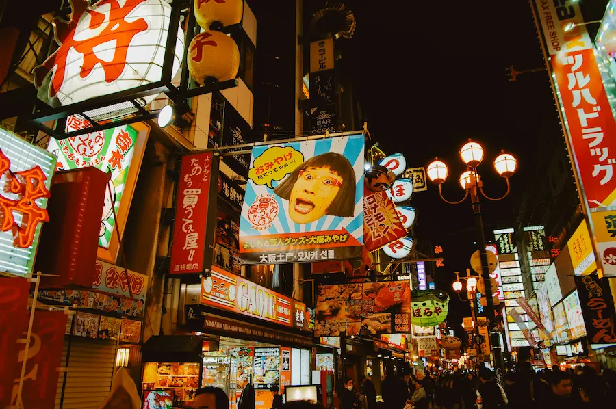 Family eating on Dotonbori Street, Osaka. 