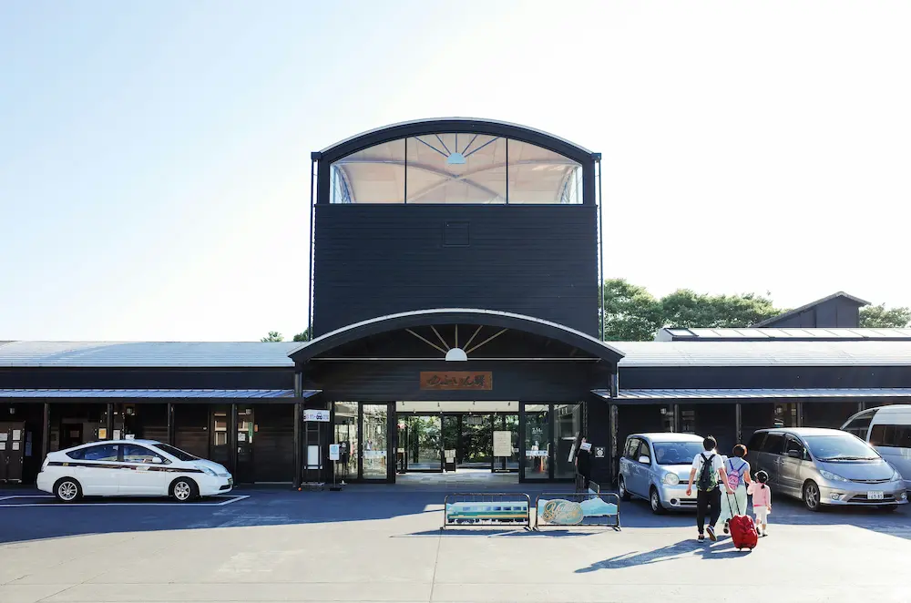 Family walking together in a calm Japanese neighborhood street.