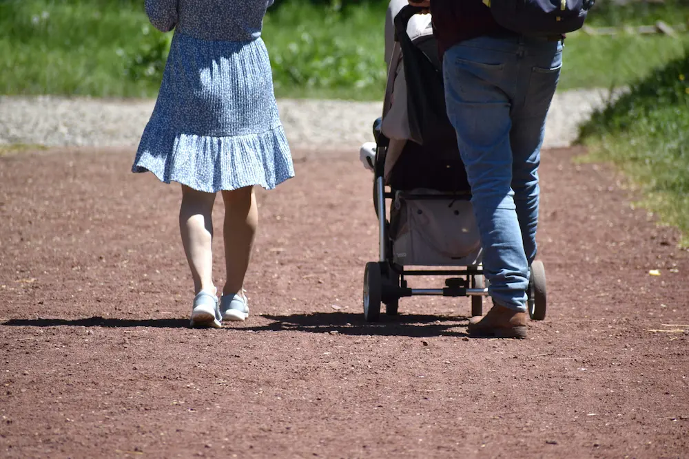 Parents carrying a stroller while traveling in Japan