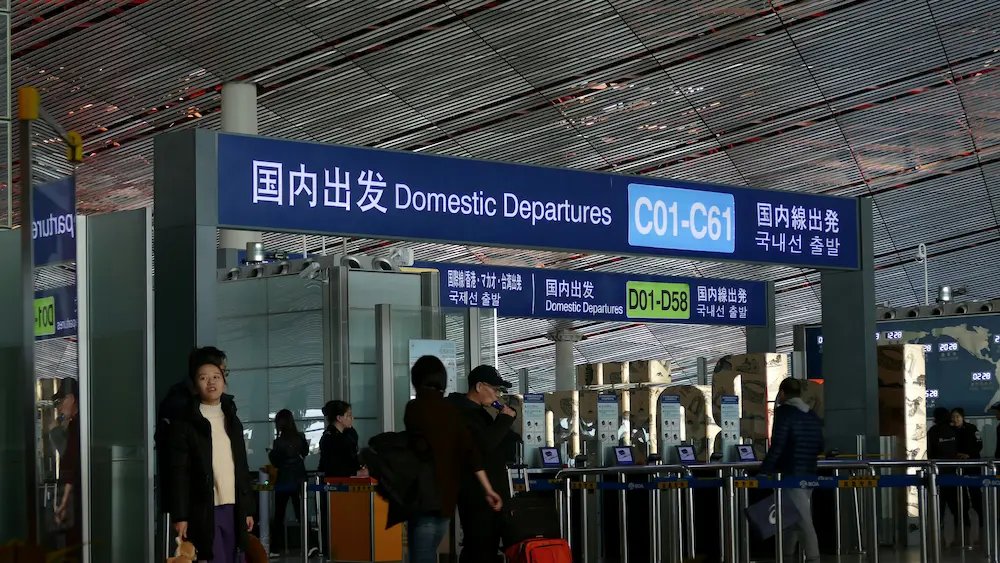 Parents are waiting at the Beijing airport in China with kids.