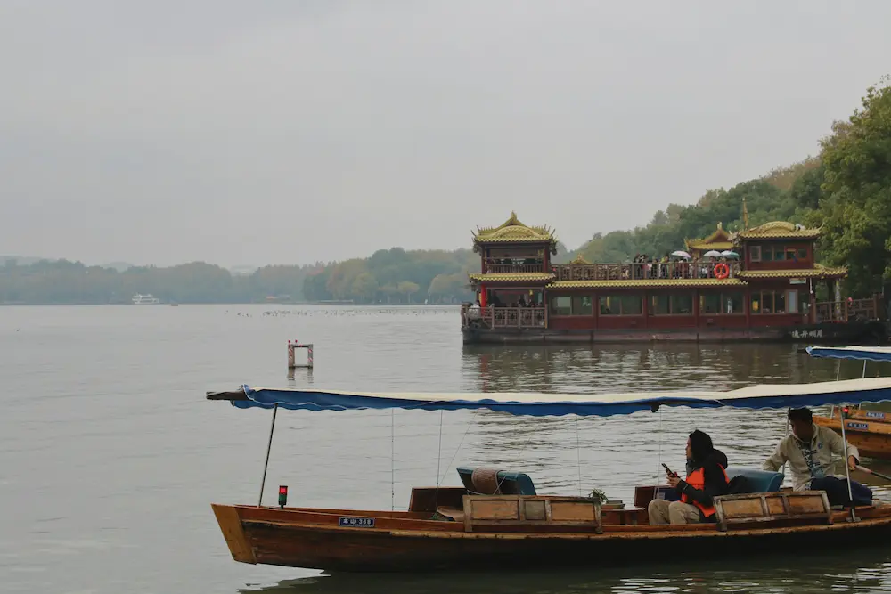 The family enjoys boating in West Lake, Hangzhou, near Shanghai. 