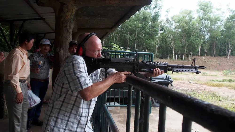 Tourists trying shooting activity at Cu Chi Tunnels near Ho Chi Minh City