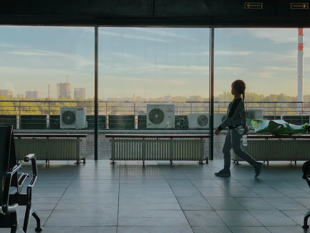 The girl is playing at the airport before a long-haul flight. 