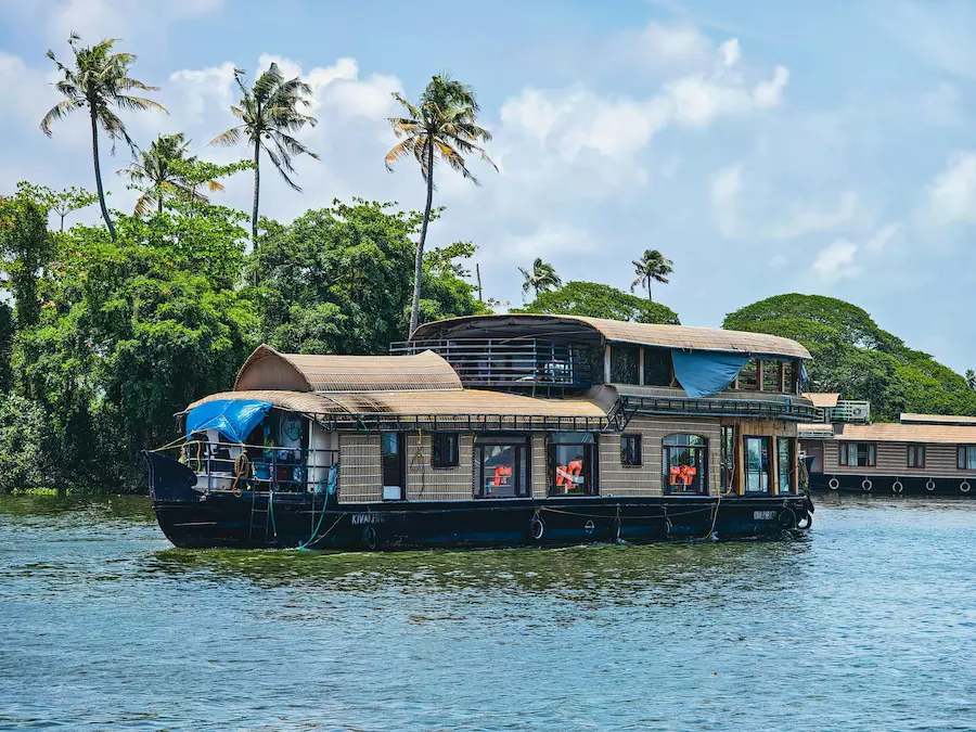 Family enjoying a backwaters houseboat ride in Kerala, India.