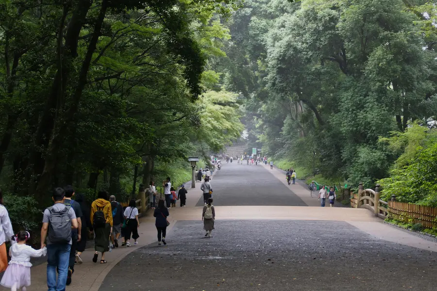 A 5-year-old walking with Mom in Tokyo Shrine pathways. 