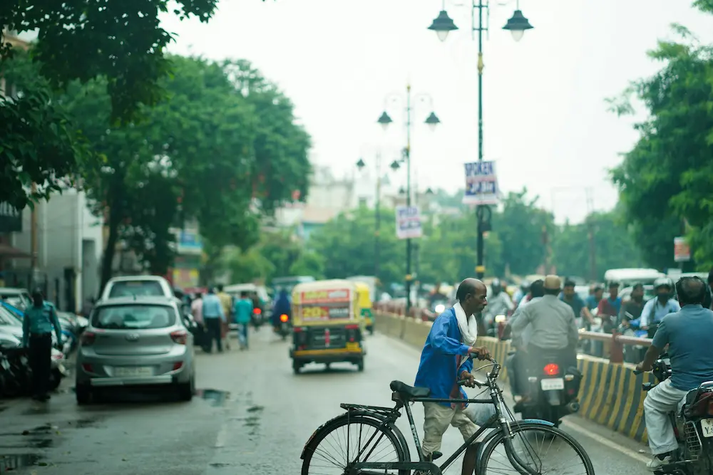 Family crossing the road in Delhi, India, in super chaotic traffic.