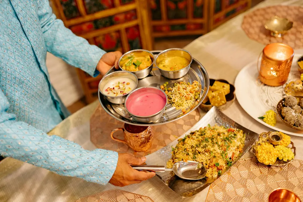 Tourists are eating Indian food in a clean, family-friendly restaurant in India.