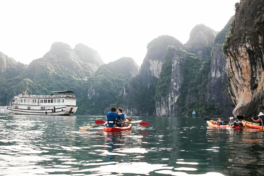 Family enjoying a boat ride with a luxury Ha Long Bay cruise ship.