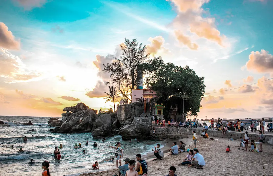Toddler playing on Phu Quoc beach at sunset during family trip to Vietnam