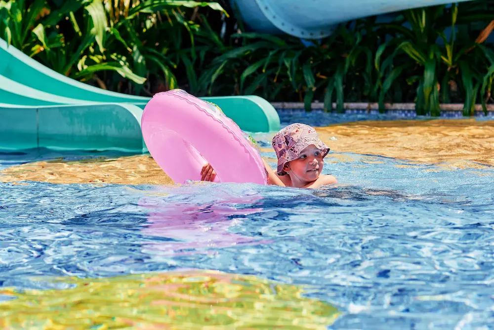Kids playing in the shallow water park area at Waterbom Bali in Kuta.