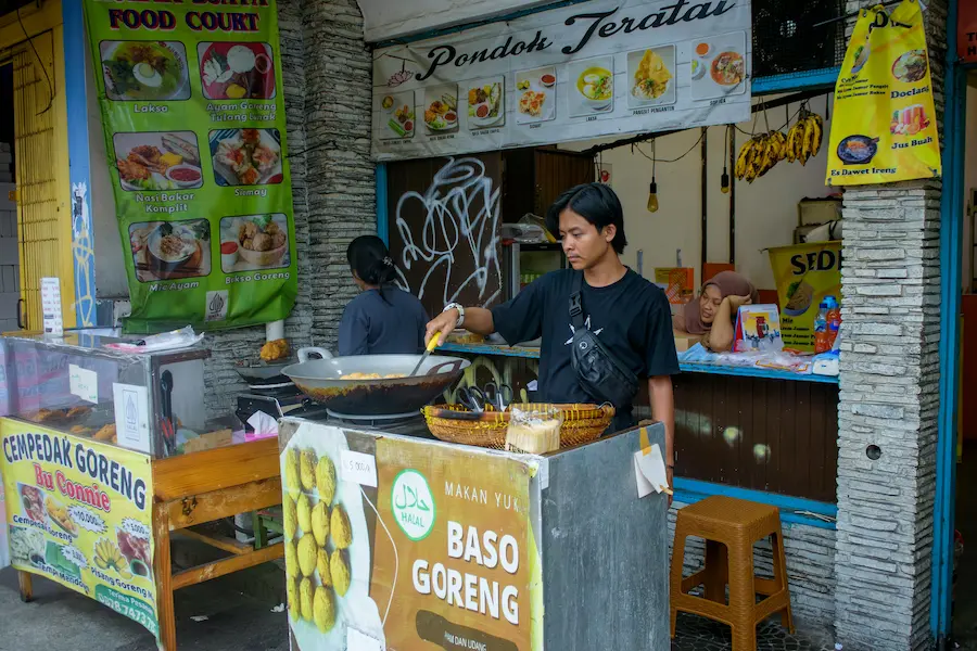 The family is trying street food in Bali.