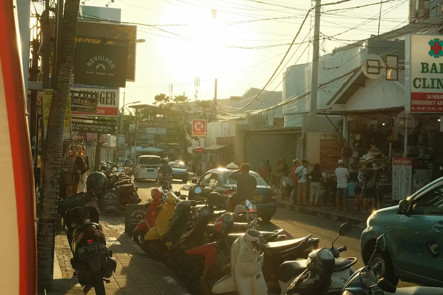 Busy scooter traffic and narrow sidewalks in Seminyak, Bali