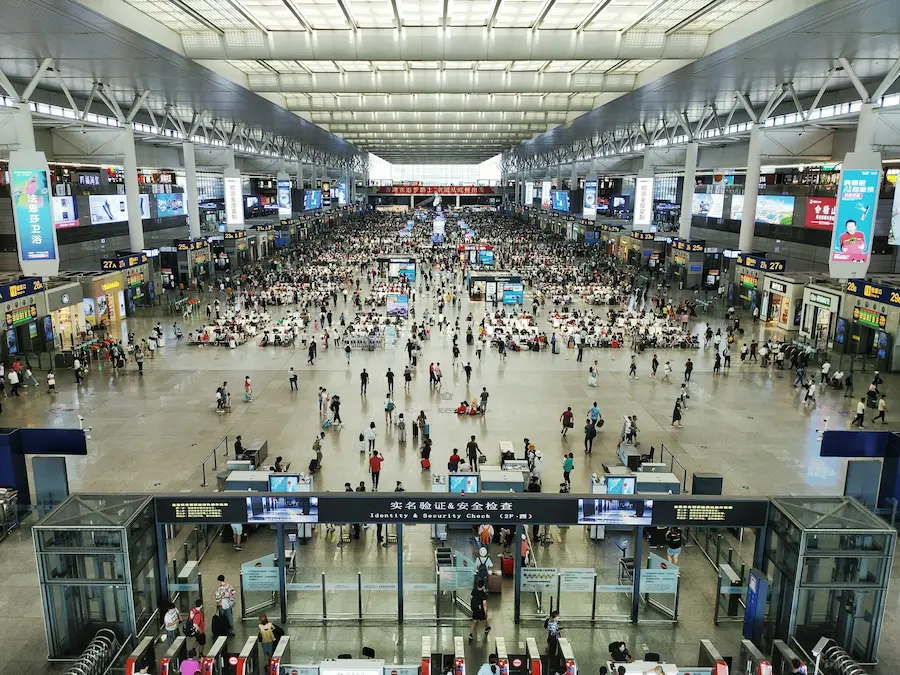 Family entering China's high-speed train with kids have luggage and stroller