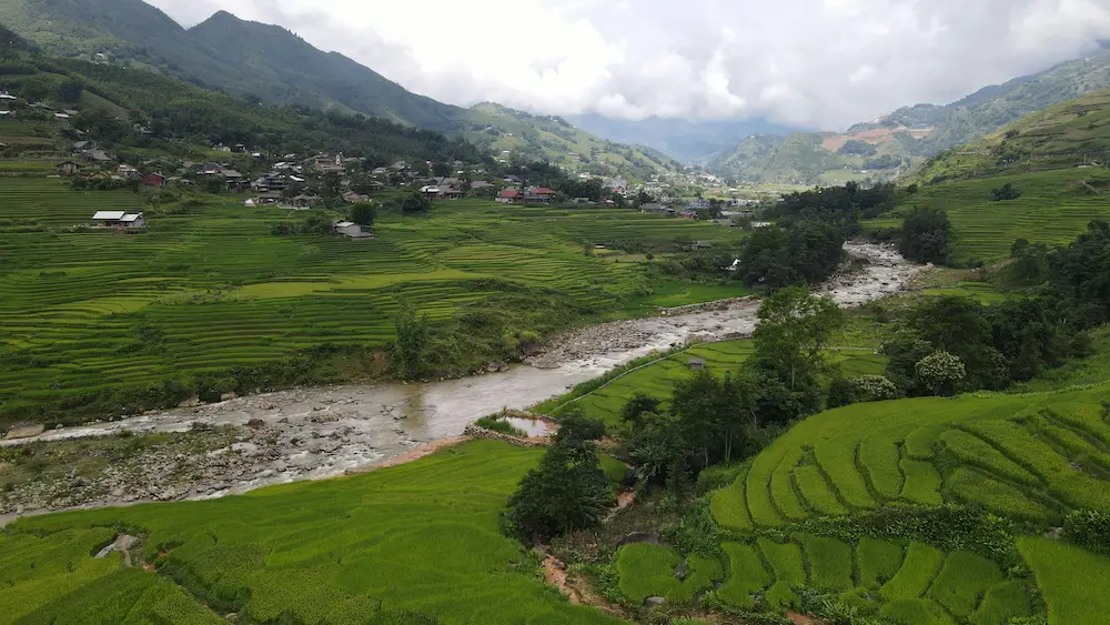 Family traveling in Sapa Vietnam looking at terraced rice fields with a toddler.