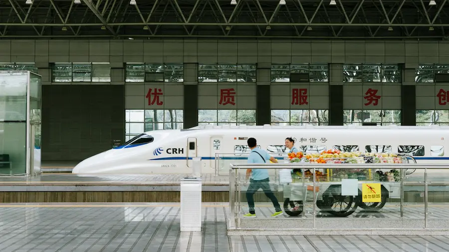 family waiting for high-speed rail in china with young kids