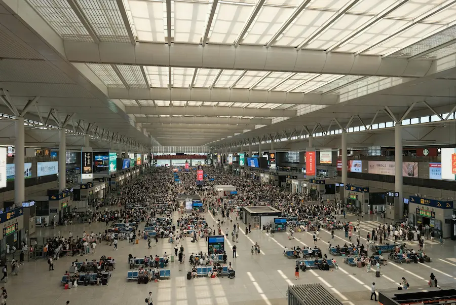family navigating the huge Shanghai train station for the first time with kids