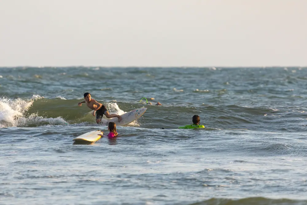 kids surfing Bali Kuta beach beginner lesson family travel