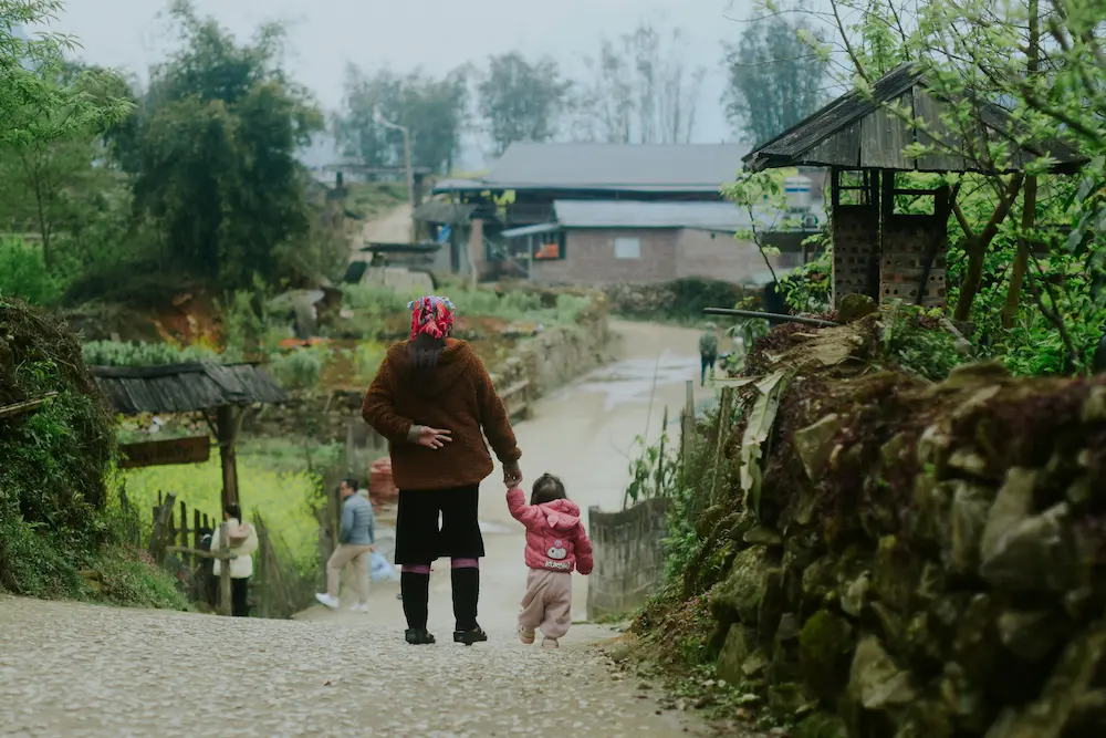 Family walking in the terrains of Sapa with kids.
