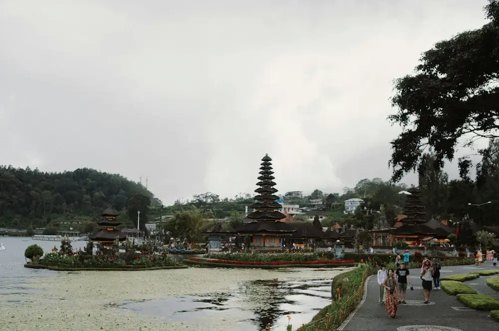 Young family exploring a traditional stone temple entry with young children on a Bali toddler travel trip.