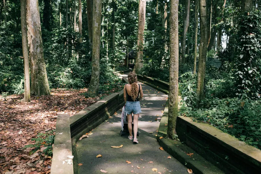 Parent using a baby carrier while exploring Bali with a toddler