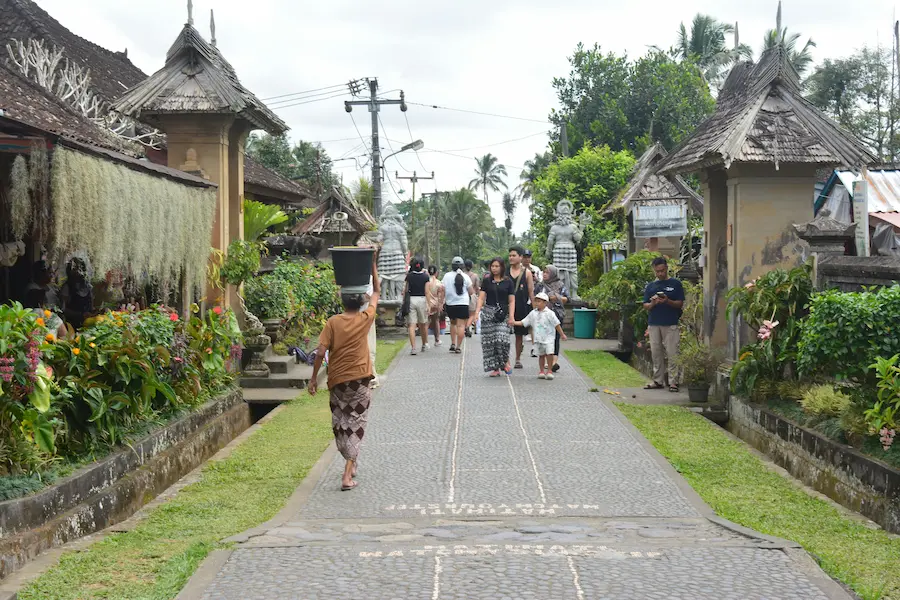 A toddler wearing a protective sun hat for heat safety tips for traveling to Bali with young children.