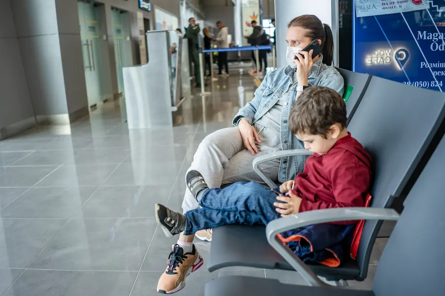 Parent setting up an eSIM before a family flight to Asia