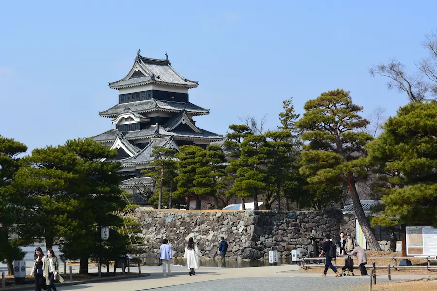 Family walking through Japan with a stroller during a sightseeing day